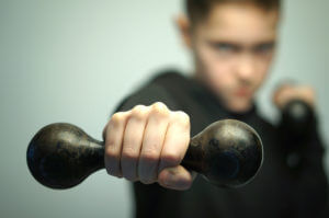 Teenage sport boy with dumbbells and stylish haircut, studio sho Teenage sport boy with dumbbells and stylish haircut, studio sho